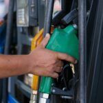 a person s hand holding a gas pump